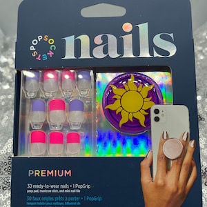 May include: A package of 30 ready-to-wear press-on nails with a purple and yellow sun design. The package includes a prep pad, manicure stick, mini nail file, and a PopGrip.