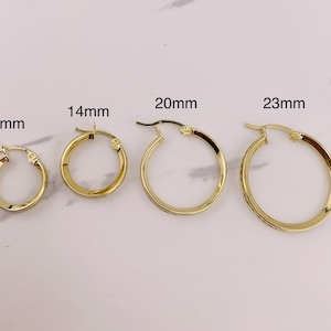 May include: Five gold hoop earrings of different sizes, measuring 13mm, 14mm, 20mm, and 23mm.