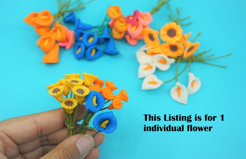 May include: Assortment of artificial flowers in various colors, including blue, orange, yellow, and white. The flowers are arranged in bunches and have a realistic appearance. This listing is for 1 individual flower.