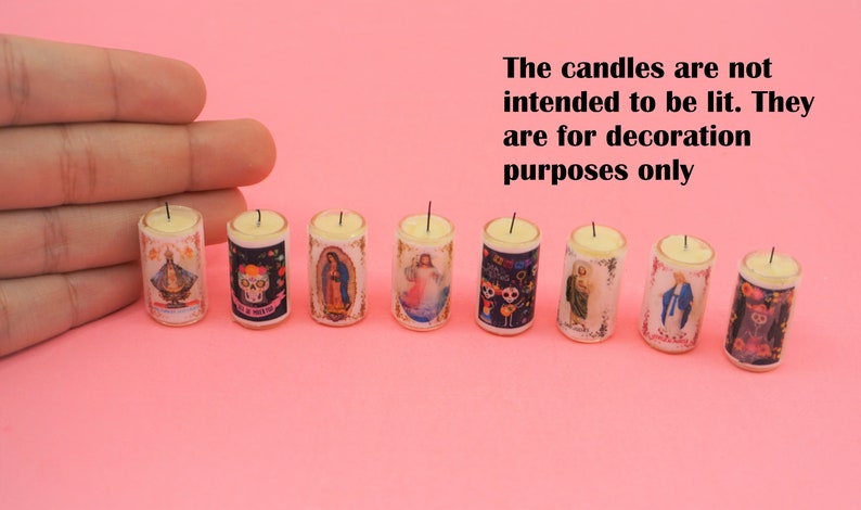 May include: Eight miniature cylindrical candles featuring various religious and cultural imagery, including skulls and figures. The text states: The candles are not intended to be lit. They are for decoration purposes only. Each candle has a small wick.