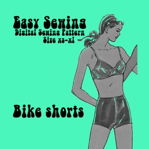 May include: A digital sewing pattern for bike shorts. The pattern is available in sizes XS-XL. The image shows a model wearing the shorts in a black and white illustration.