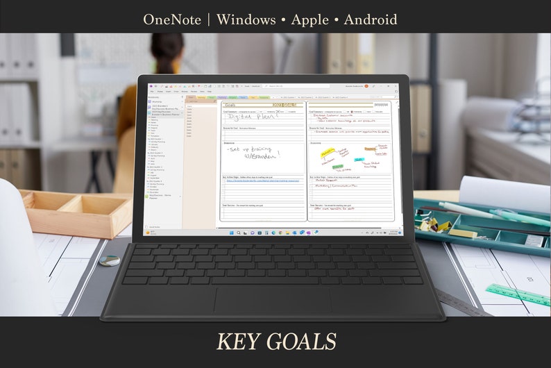 May include: A laptop computer displaying a digital planner with the text "Key Goals" on the screen. The planner is open to a page with the heading "Daily Planning" and includes sections for "Today's Focus", "Weekly Review", and "Key Goals". The laptop is on a desk with a wooden surface and a pencil holder.