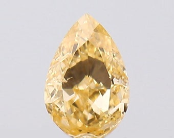 May include: A pear-shaped, yellow diamond gemstone with a brilliant cut.