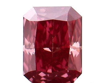 May include: A vibrant red and pink gemstone with a rectangular shape and a faceted cut. The gemstone is a loose diamond.