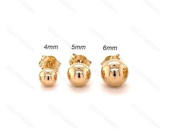 May include: Three gold ball stud earrings in 4mm, 5mm, and 6mm sizes are displayed. The earrings are round, polished, and reflective, with a post and butterfly backing. The text "4mm", "5mm", and "6mm" is above each earring.