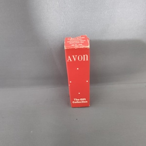 May include: A red Avon box with white text and small white dots. The box reads "Sugary Scents Collection Chocolate Mint Diffuser Oil 1.8 FL. OZ." and "AVON" in large white letters. The bottom of the box reads "The Gift Collection."