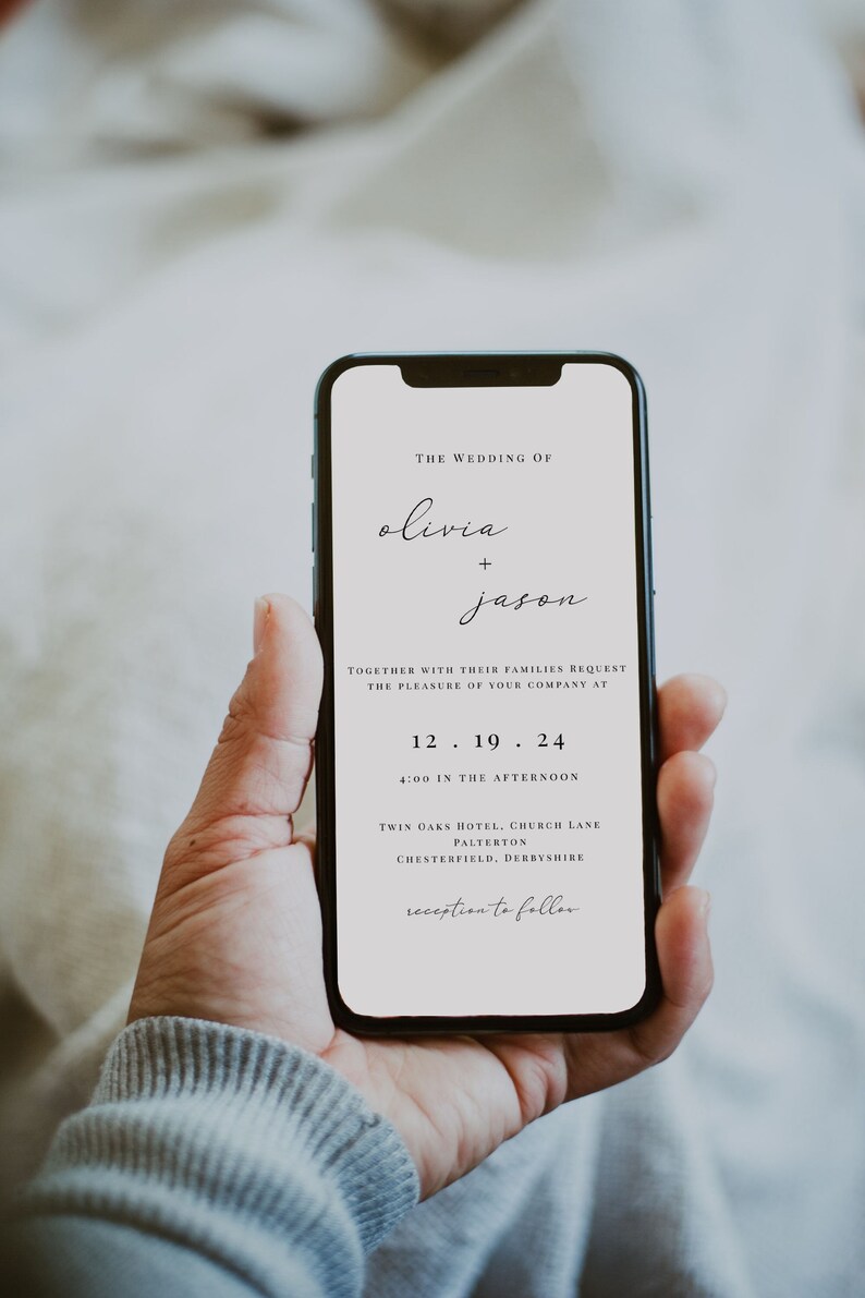 May include: A smartphone displaying a wedding invitation for Olivia and Jason. The invitation includes the date, time, and location of the wedding ceremony and reception. The text reads: "The Wedding of Olivia + Jason. Together with their families request the pleasure of your company at 12.19.24 4:00 in the afternoon. Twin Oaks Hotel, Church Lane, Palterton, Chesterfield, Derbyshire. Reception to follow."