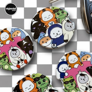 May include: Car coasters with colorful cartoon animal designs. The coasters feature a variety of characters, including a tiger, frog, cat, and bear. The coasters are round and have a small indentation for easy removal. The shop logo "ninjaeriell SHOP" is visible.