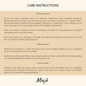 May include: A beige card with black text detailing jewelry care instructions. The text includes what to avoid, how to store, and how to clean jewelry. The brand name "Majo" is at the bottom.