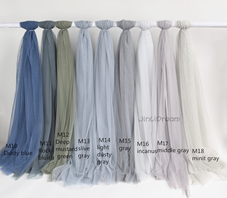 May include: Eight different colors of sheer fabric swatches, labeled with their color names and product codes. The colors are dusty blue, rock bluish, deep mustard green, olive gray, light dusty gray, gray, incanus, middle gray, and minit gray.