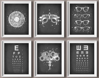 May include: Set of six black and white printable posters with an eye exam theme. The posters feature an eye, an eye chart, a trial frame, and various eyeglasses.