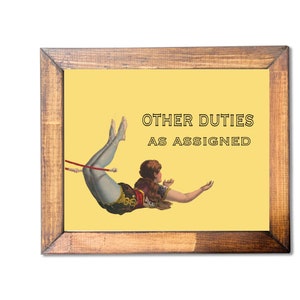 May include: Wooden framed print with a yellow background featuring a vintage illustration of a person in a circus act. The text "OTHER DUTIES AS ASSIGNED" is displayed in black letters. The frame is made of brown wood.