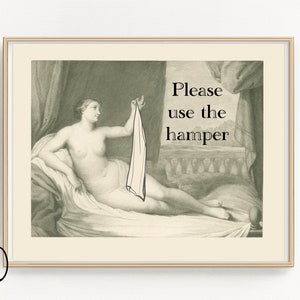 May include: A black and white vintage illustration of a woman lying down, holding a white cloth. The text "Please use the hamper" is written in black text on a white background.