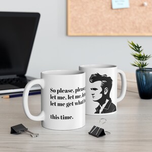May include: Two white ceramic mugs. One mug features the text "So please, please let me, let me, let me get what this time." The other mug has a black and white illustration of a man's profile.