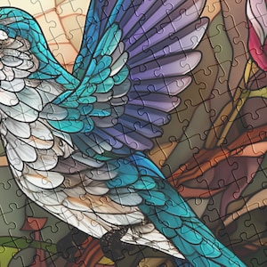 May include: A completed jigsaw puzzle featuring a vibrant hummingbird with blue, teal, and white feathers. The bird is set against a backdrop of stylized flowers in shades of pink and red. The puzzle pieces are visible, creating a stained-glass effect.