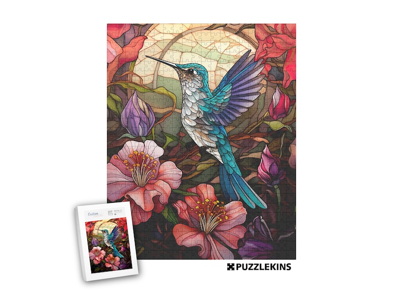 May include: A colorful jigsaw puzzle featuring a hummingbird with turquoise and purple feathers, surrounded by pink and red flowers. The puzzle has a stained-glass style with a full moon in the background. A smaller image of the puzzle is in the lower left corner.