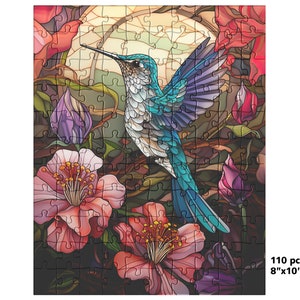 May include: A 110-piece jigsaw puzzle featuring a colorful hummingbird with blue, white, and purple feathers, set against a backdrop of pink and red flowers. The puzzle measures 8" x 10".