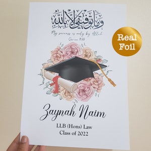 May include: A graduation certificate with a black graduation cap and a scroll, surrounded by pink and white flowers. The text "My success is only by Allah Qur'an 11:88" is written in Arabic calligraphy. The name "Zaynah Naim" is written below the flowers, along with the text "LLB (Hons) Law Class of 2022".