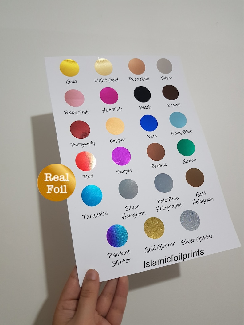 May include: A chart of different colored foil sheets, including gold, silver, red, blue, green, purple, and black. The chart also includes holographic and glitter foil options. The text "Real Foil" and "Islamicfoilprints" are visible on the chart.