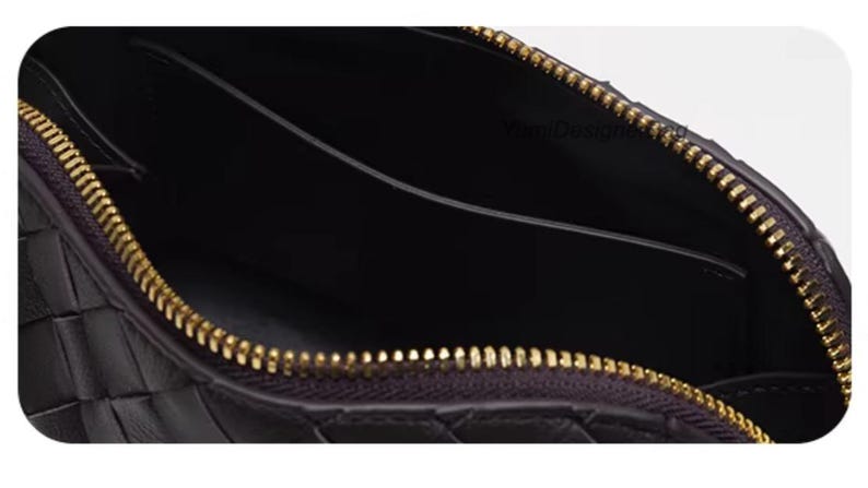 K&ouml;nnte beinhalten: Nahaufnahme einer schwarzen Leder-Clutch mit einem gewebten Muster. Der Innenraum ist dunkel, und der goldene Rei&szlig;verschluss ist ge&ouml;ffnet, wodurch das Innere sichtbar wird. Ein stilvolles Accessoire.