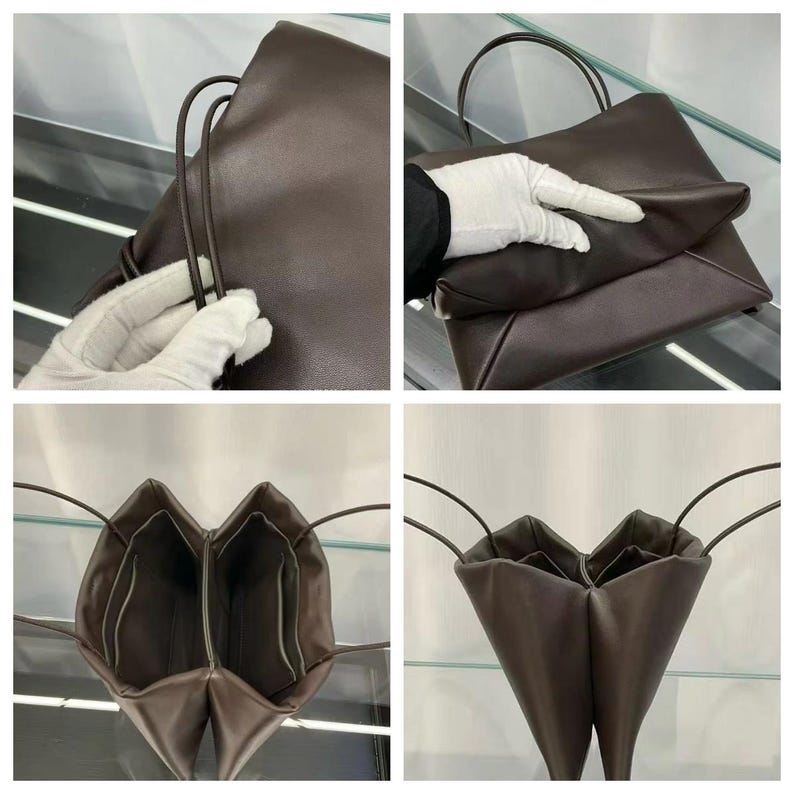 May include: A dark brown leather handbag featuring a smooth, matte finish and thin, rounded shoulder straps. The bag has a structured, multi-compartment interior design with a fold-over top closure and clean, minimalist lines throughout the exterior.