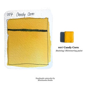 May include: A watercolor paint sample in a yellow color called "Candy Corn". The paint is described as "Staining/Shimmering paint".