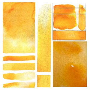 May include: A collection of watercolor swatches in various shades of yellow. The swatches are arranged in a grid pattern and show the different shades of yellow that can be achieved with watercolor paint.