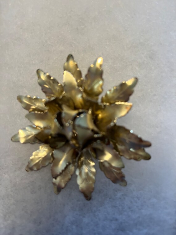 Coro metal gold tone dimensional flower.