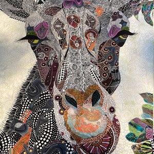 May include: A close-up of a colorful, patterned quilt featuring a giraffe's head. The giraffe's face is detailed with black and white lines, and its eyes are outlined in black with yellow pupils. The quilt is made of various fabrics, including black, white, purple, orange, and green.