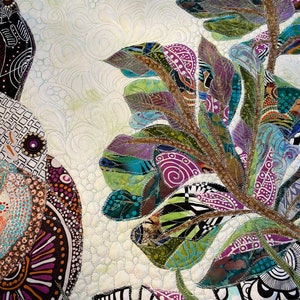 May include: A close-up of a colorful quilt with a floral design. The quilt is made of different fabrics and textures, and the flowers are stitched together with intricate detail. The quilt is a beautiful example of handmade art.