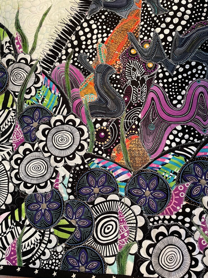May include: A colorful abstract quilt with a black and white background. The quilt features a variety of shapes and patterns, including circles, swirls, and flowers. The quilt is made of different fabrics, including cotton and silk.