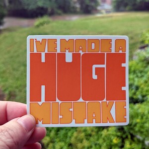 Puede incluir: Una pegatina con el texto "I've made a HUGE mistake" en letras naranjas y amarillas sobre un fondo blanco.