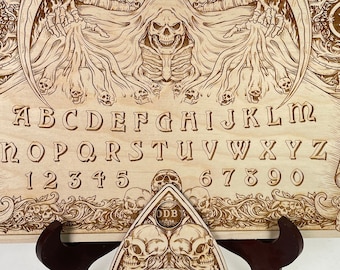 Ouija board with demons and skulls engraved on wood , wooden spirit board with planchette in gothic style with reaper pulling out souls