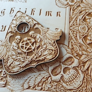 Ouija board with demons and skulls wooden engraving, wood gothic skull spirit board.