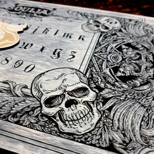 Ouija board with planchette for spiritualism, demons and skulls wooden engraving dark , wood gothic skull spirit board in vintage look