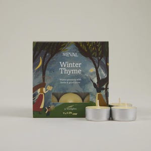 May include: A box of nine Winter Thyme tealights with a decorative illustration. The box features a nighttime forest scene with the text "Winter Thyme" and "Winter greenery with herbs & good cheer". Several tealights are visible.