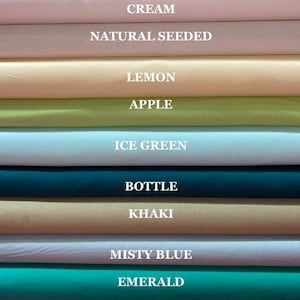 May include: A stack of fabric swatches in various colors, including cream, natural seeded, lemon, apple, ice green, bottle, khaki, misty blue, and emerald.