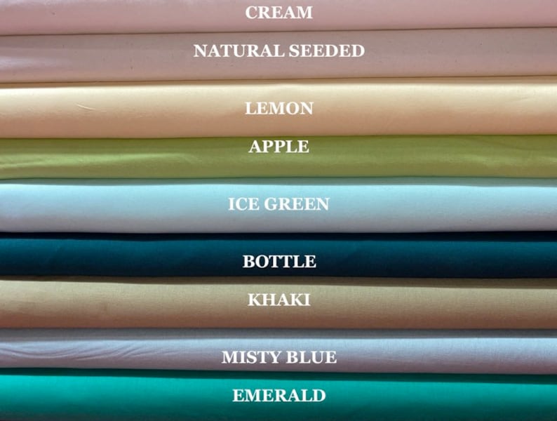 May include: A stack of fabric swatches in various colors, including cream, natural seeded, lemon, apple, ice green, bottle, khaki, misty blue, and emerald.