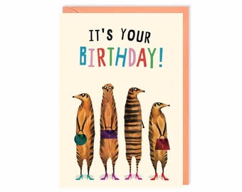 May include: Birthday greeting card with the text "IT'S YOUR BIRTHDAY!" in colorful letters. The card features four cartoon meerkats wearing high heels and carrying purses. The card has a peach-colored border.