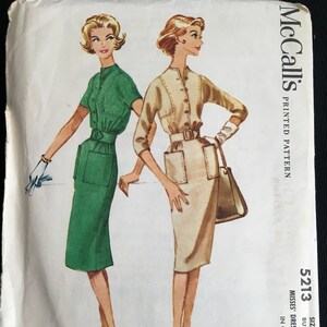 May include: Vintage McCall's sewing pattern for a misses' dress. The pattern is for size 14, bust 34, and includes two dress styles. The dress on the left is green and the dress on the right is beige.