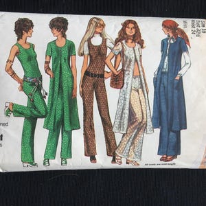 May include: Vintage Simplicity sewing pattern envelope showing illustrations of women's clothing designs. The designs include jumpsuits, dresses, and long coats. The envelope is cream-coloured with text and illustrations in various colours. The text reads "Designed for knit fabrics only."