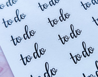 May include: A sheet of white paper with multiple black "to do" stickers. The stickers are printed in a cursive font.