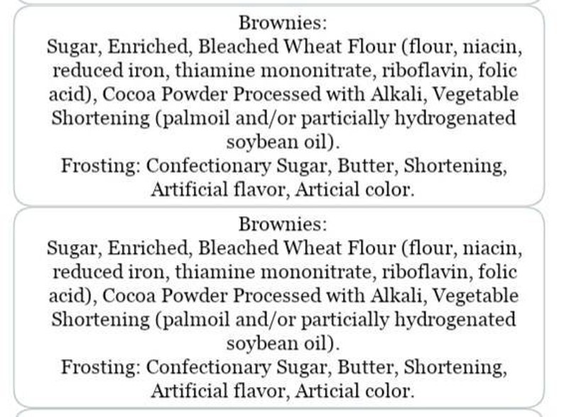 May include: Two white rectangular labels detailing the ingredients for brownies and frosting. The labels list ingredients including sugar, flour, cocoa powder, and shortening.