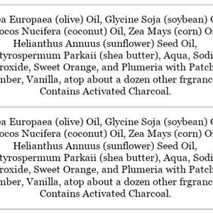 May include: Two white labels with black text detailing ingredients such as olive oil, shea butter, and activated charcoal. The labels describe the ingredients of a product, possibly soap or skincare.