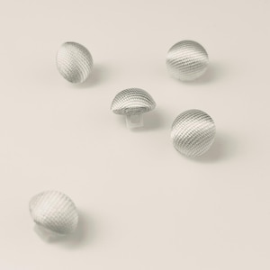 May include: Several silver-toned buttons with a woven texture. One button is mushroom-shaped with a small stem. The buttons are scattered on a white surface. Suitable for sewing and craft projects. The buttons are approximately 1.5 cm in diameter.