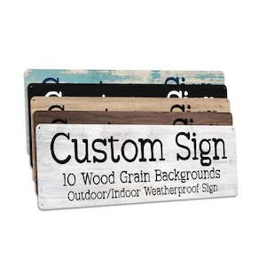 May include: A stack of five rectangular signs with rounded corners and small holes for mounting. The top sign is white with a wood grain texture and black text reading Custom Sign 10 Wood Grain Backgrounds Outdoor/Indoor Weatherproof Sign.