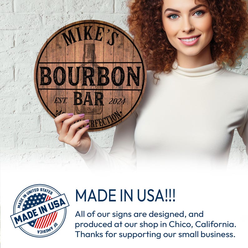 May include: A round wooden sign with the text "MIKE'S BOURBON BAR EST 2024" in black lettering. The sign features a bourbon bottle illustration. The sign is held by a person.