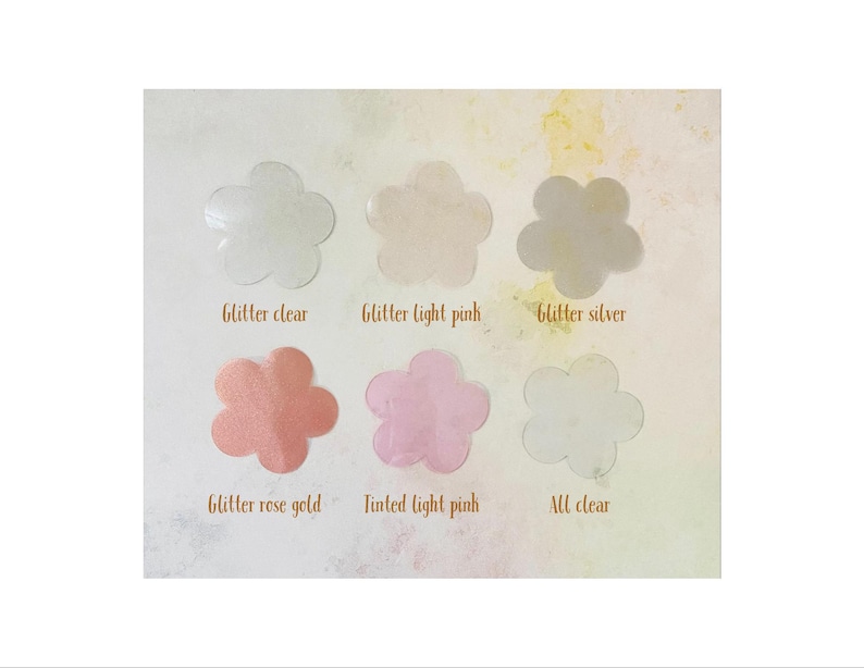 May include: Six flower-shaped samples of clear, glitter-infused resin in various colors, including clear, light pink, silver, rose gold, tinted light pink, and all clear. The samples are labeled with their corresponding names.