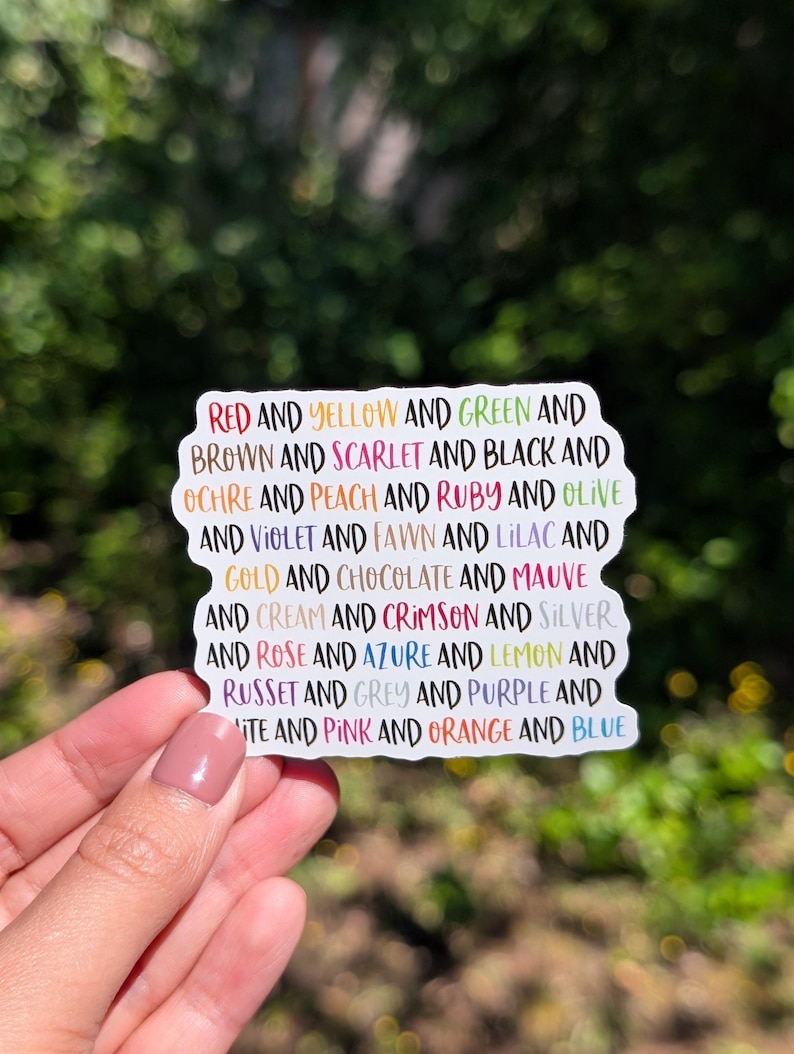 May include: A die-cut sticker featuring a list of colour names printed in various corresponding ink colours. The text reads: RED AND YELLOW AND GREEN AND BROWN AND SCARLET AND BLACK AND OCHRE AND PEACH AND RUBY AND OLIVE AND VIOLET AND FAWN AND LILAC AND GOLD AND CHOCOLATE AND MAUVE AND CREAM AND CRIMSON AND SILVER AND ROSE AND AZURE AND LEMON AND RUSSET AND GREY AND PURPLE AND WHITE AND PINK AND ORANGE AND BLUE.