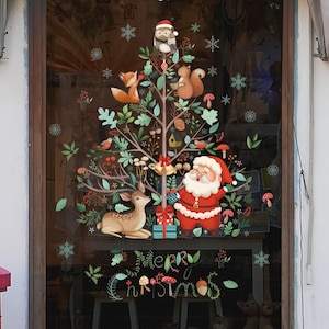 May include: A window decal featuring a Christmas tree design with Santa Claus, a deer, and woodland creatures. The tree is adorned with ornaments, snowflakes, and the words "Merry Christmas". The color palette includes red, green, brown, and white.